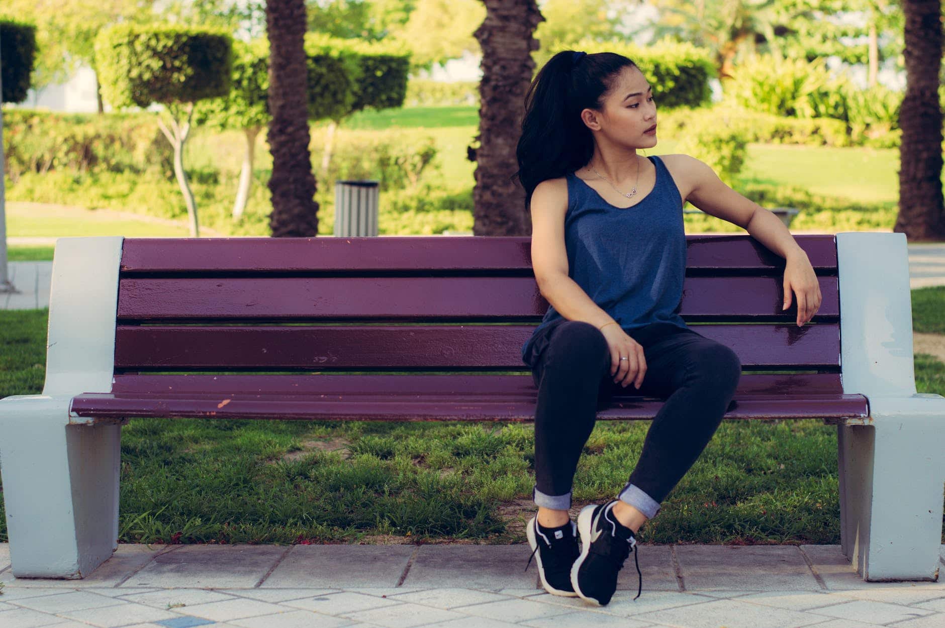 woman sitting on purple bench