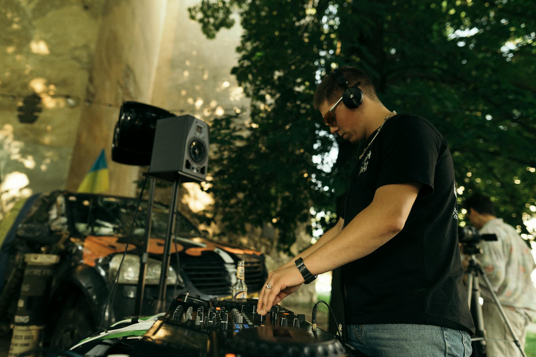 a dj using a console to play music outside