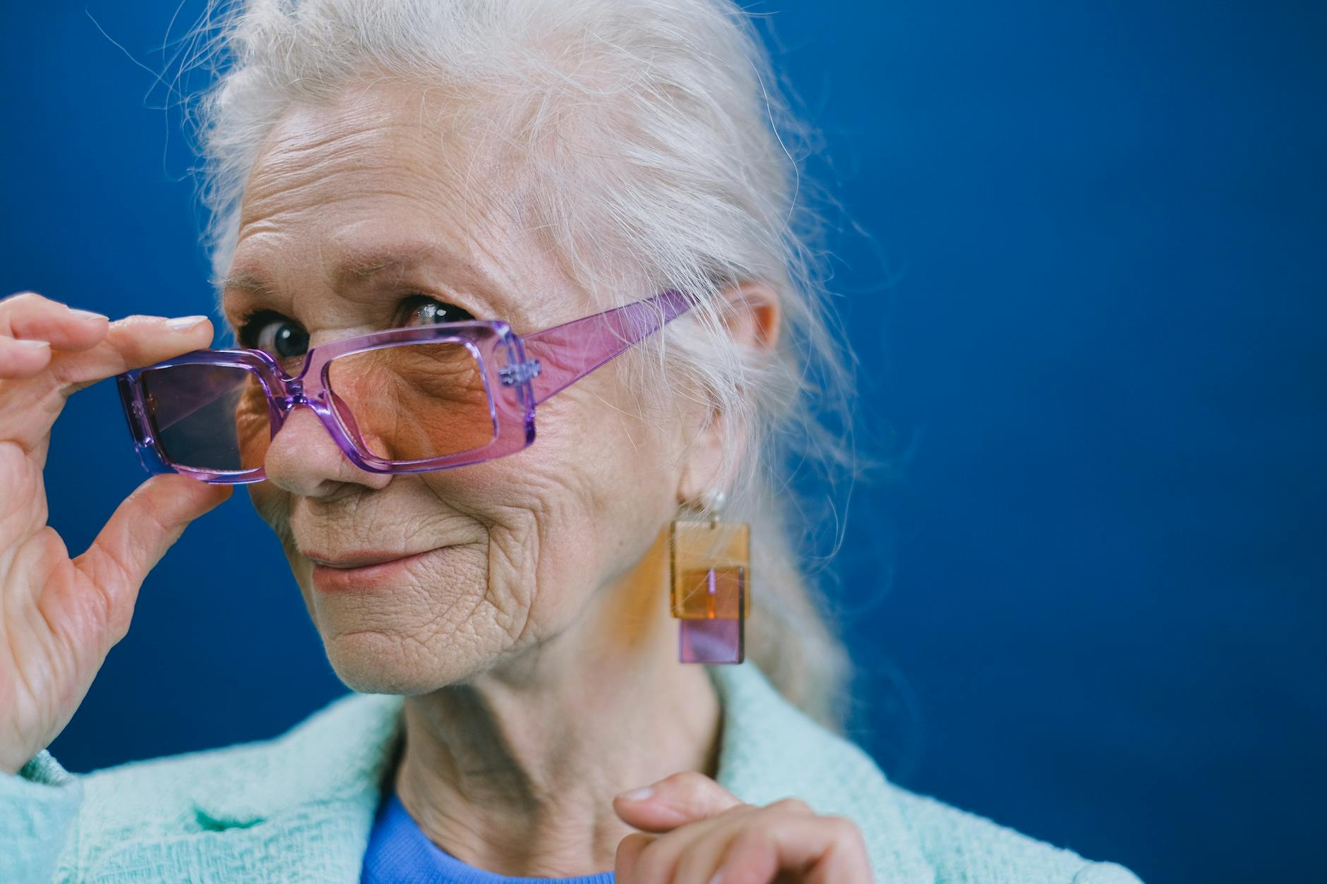 senior woman in eyeglasses and earrings